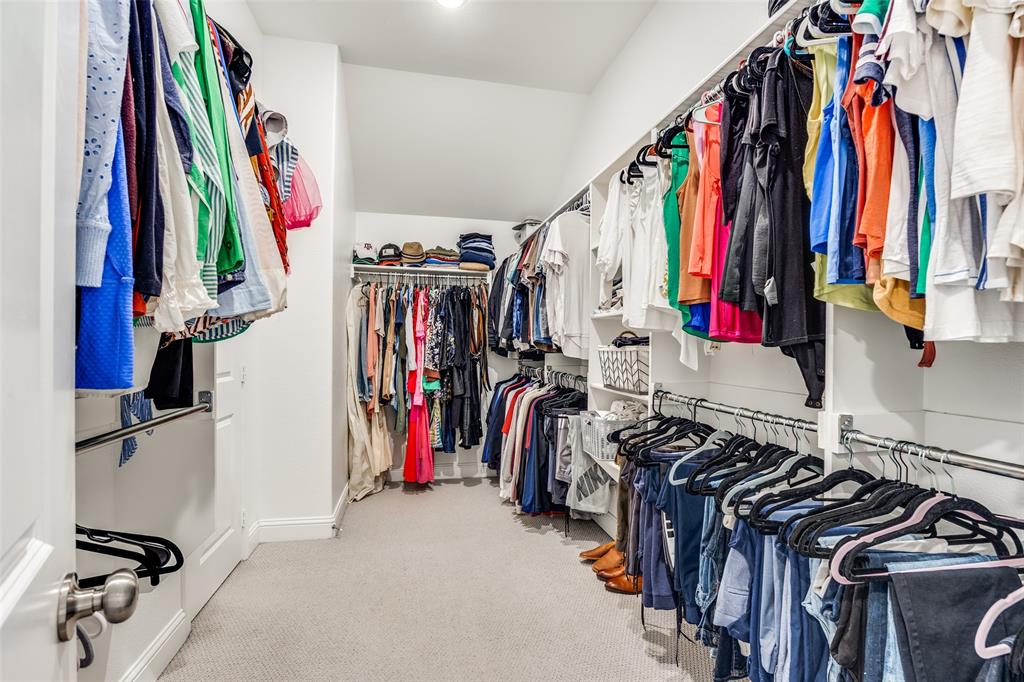1036 Drew Lane Allen, TX 75013 - Photo 30 of 38 a view of walk in closet with clothes