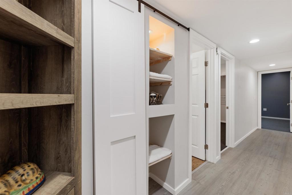 4180 Galbar Place Oceanside, CA 92056 - Photo 17 of 41 a view of hallway with wooden floor and furniture