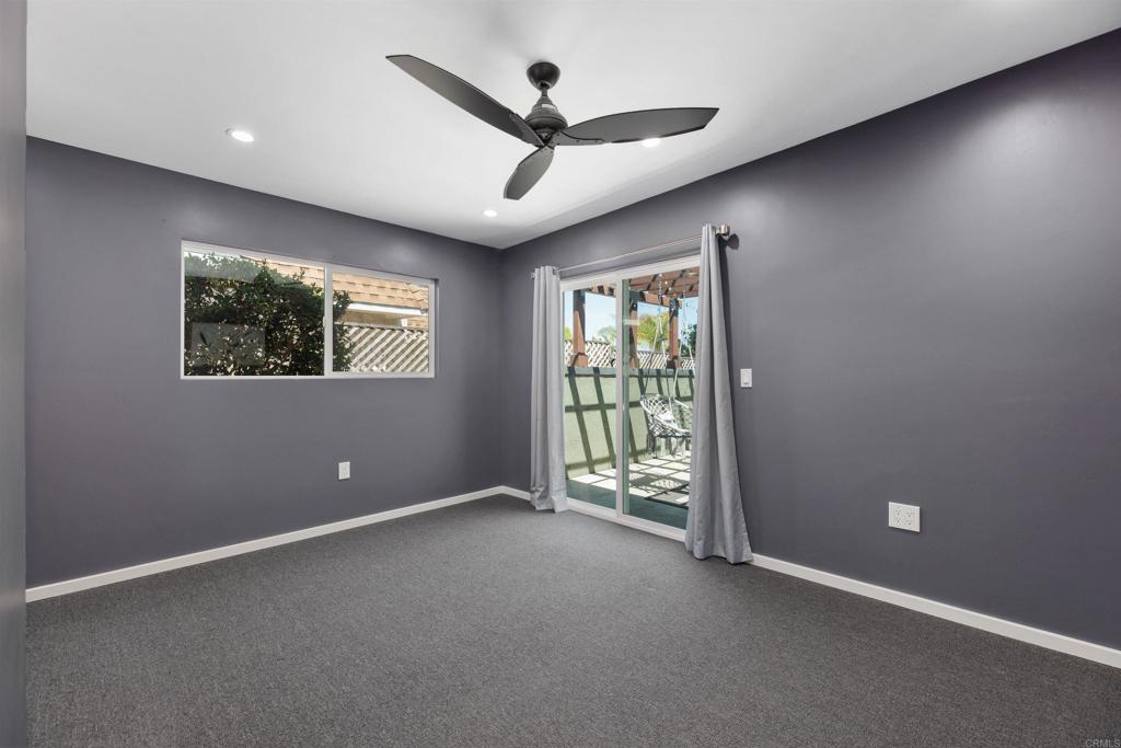 4180 Galbar Place Oceanside, CA 92056 - Photo 18 of 41 an empty room with windows and ceiling fan