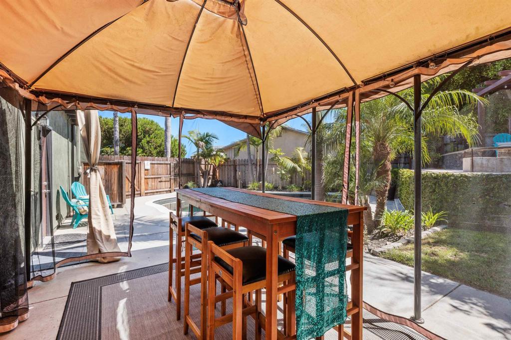 4180 Galbar Place Oceanside, CA 92056 - Photo 24 of 41 a patio with a yard table and chairs