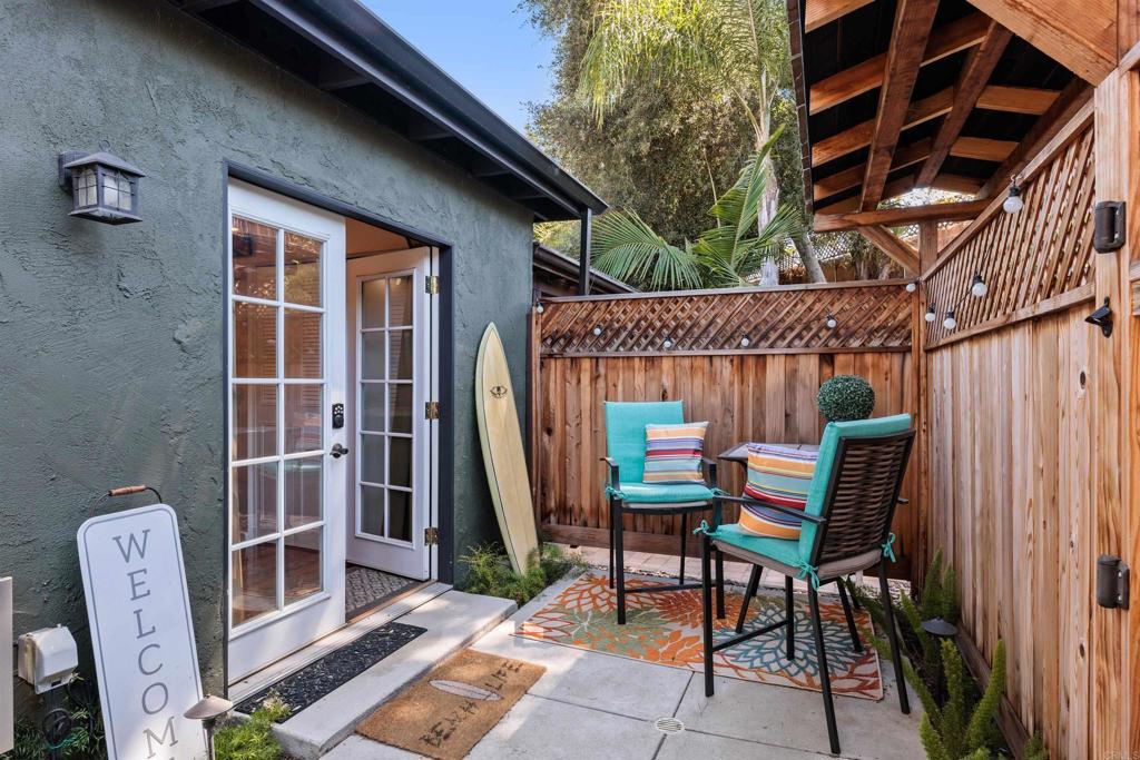 4180 Galbar Place Oceanside, CA 92056 - Photo 27 of 41 a patio with a table and chairs and potted plants