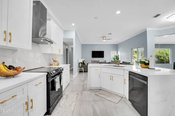 a kitchen with a sink a stove and cabinets