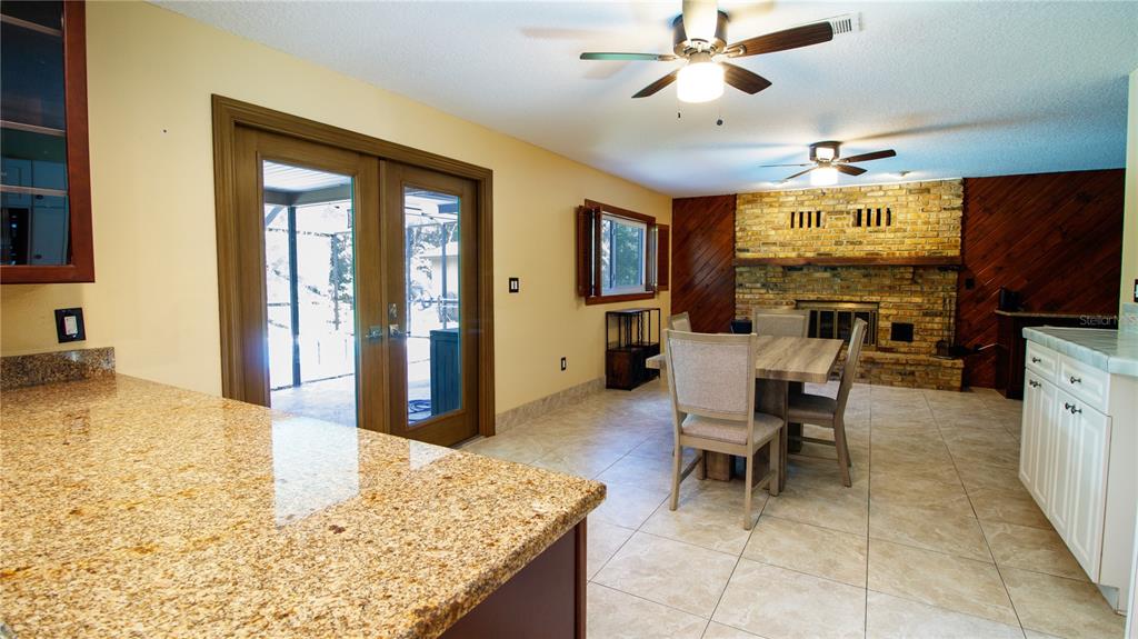 1357 Dinsmore Court New Port Richey, FL 34655 - Photo 16 of 60 a living room with fireplace furniture and a flat screen tv