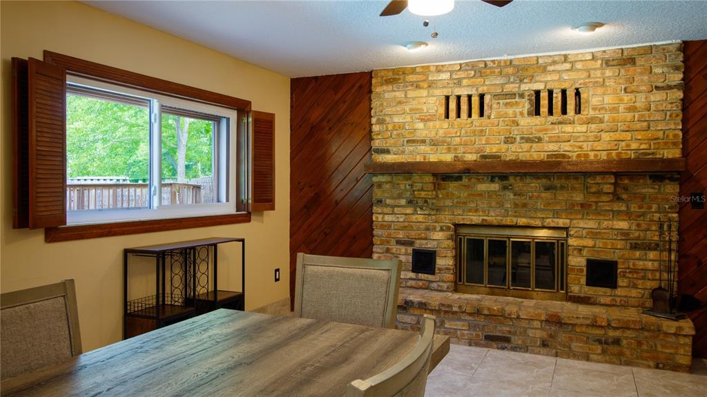1357 Dinsmore Court New Port Richey, FL 34655 - Photo 19 of 60 a living room with a fireplace and a table