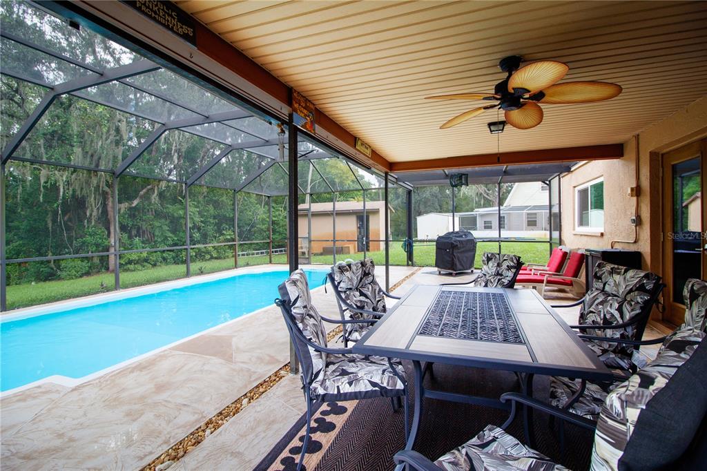1357 Dinsmore Court New Port Richey, FL 34655 - Photo 20 of 60 a view of a patio with a dining table and chairs