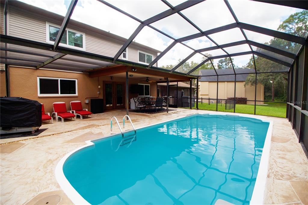 1357 Dinsmore Court New Port Richey, FL 34655 - Photo 27 of 60 a view of a swimming pool with a patio