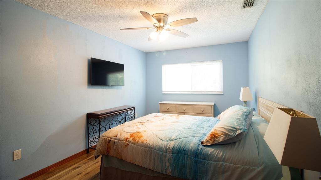 1357 Dinsmore Court New Port Richey, FL 34655 - Photo 36 of 60 a bedroom with a bed and a flat screen tv