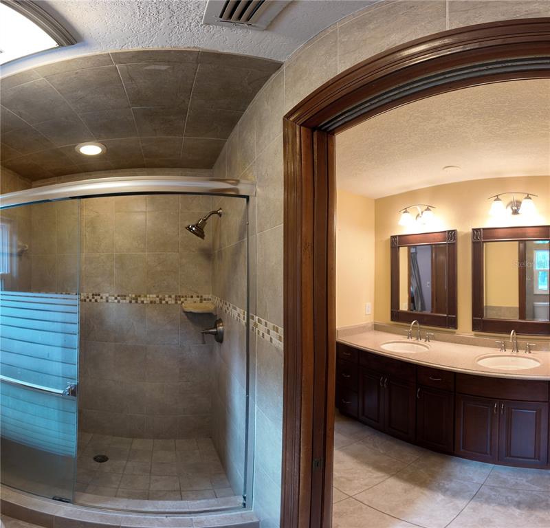 1357 Dinsmore Court New Port Richey, FL 34655 - Photo 40 of 60 a bathroom with a double vanity sink mirror and shower