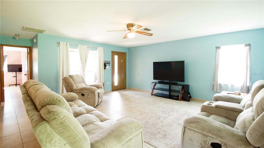 1357 Dinsmore Court New Port Richey, FL 34655 - Photo 43 of 60 a living room with furniture and a flat screen tv
