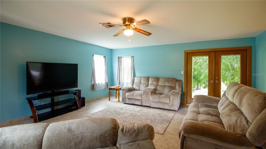 1357 Dinsmore Court New Port Richey, FL 34655 - Photo 44 of 60 a living room with furniture and a flat screen tv