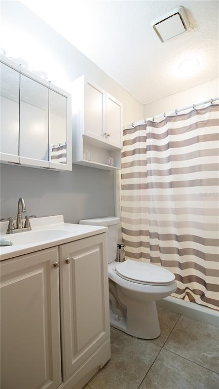 1357 Dinsmore Court New Port Richey, FL 34655 - Photo 51 of 60 a bathroom with a sink a toilet and mirror