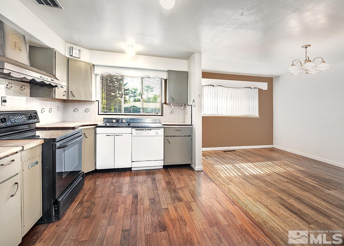 735 Brookfield Drive Reno, NV 89503 - Photo 9 of 23 a kitchen with stainless steel appliances granite countertop wooden floors and white cabinets