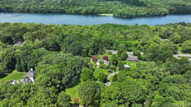 an aerial view of a house with a yard and lake view