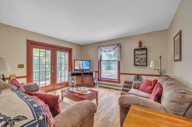 a living room with furniture large window and a flat screen tv