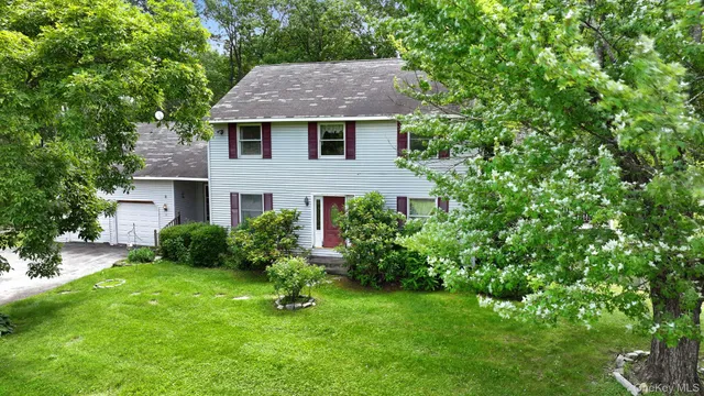 a aerial view of a house next to a yard