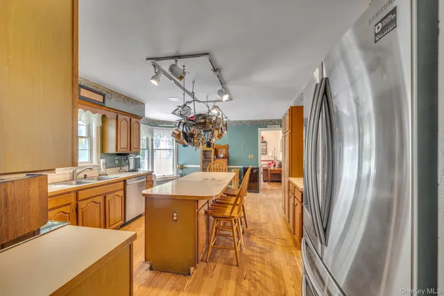 a kitchen with stainless steel appliances a sink stove and refrigerator