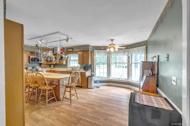 a dining room with furniture and a large window