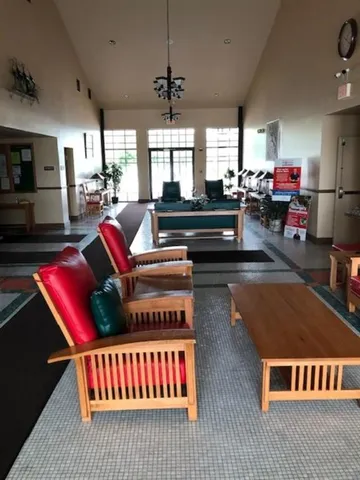 a living room with furniture pool table flat screen tv and windows