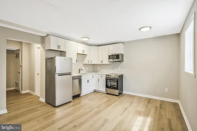 a kitchen with stainless steel appliances a refrigerator sink and microwave
