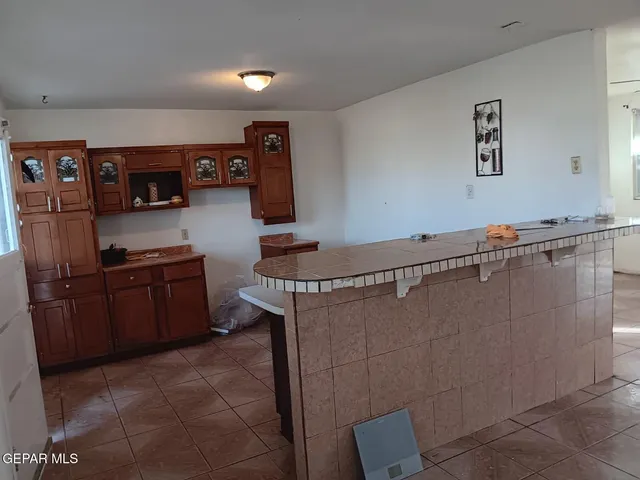 a kitchen with a refrigerator and cabinets