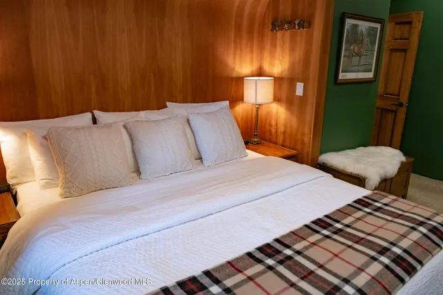 a bedroom with two beds and painted walls