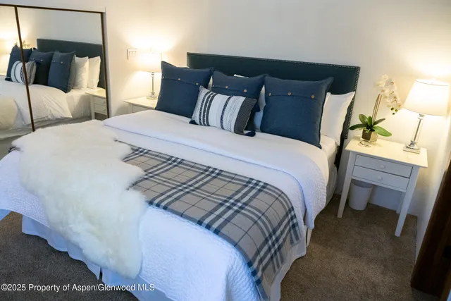 a bedroom with bed and a night stand