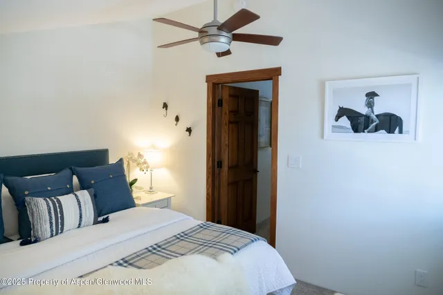 a bedroom with a bed and a painting on the wall