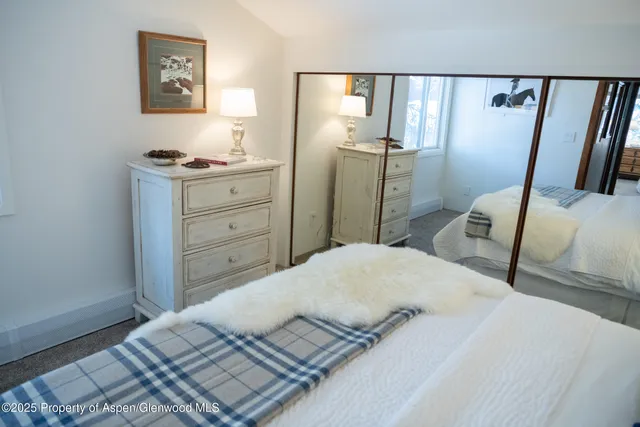 a bedroom with a bed and a dresser