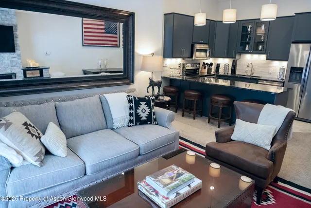 a living room with furniture and painting on the wall