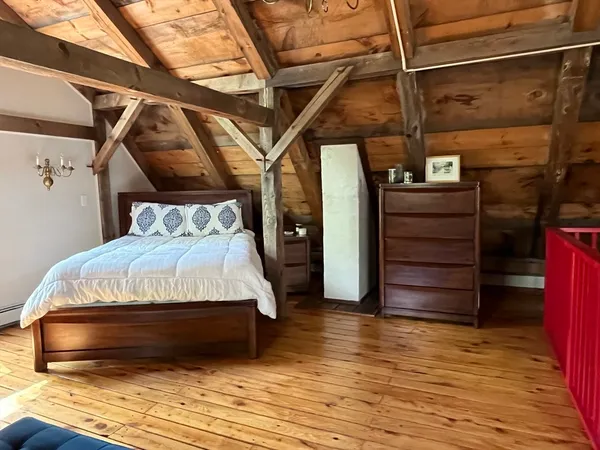 a bedroom with a bed and a mirror