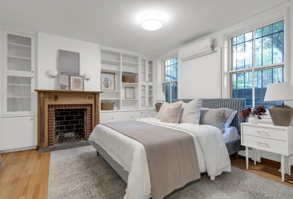 72 Rutland Street, Unit 1 Boston, MA 02118 - Photo 11 of 29 a spacious bedroom with a bed and a fireplace