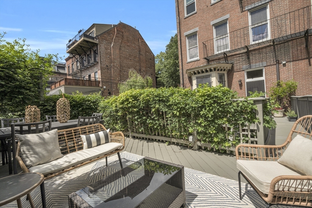 72 Rutland Street, Unit 1 Boston, MA 02118 - Photo 24 of 29 a view of a roof deck with couches and potted plants