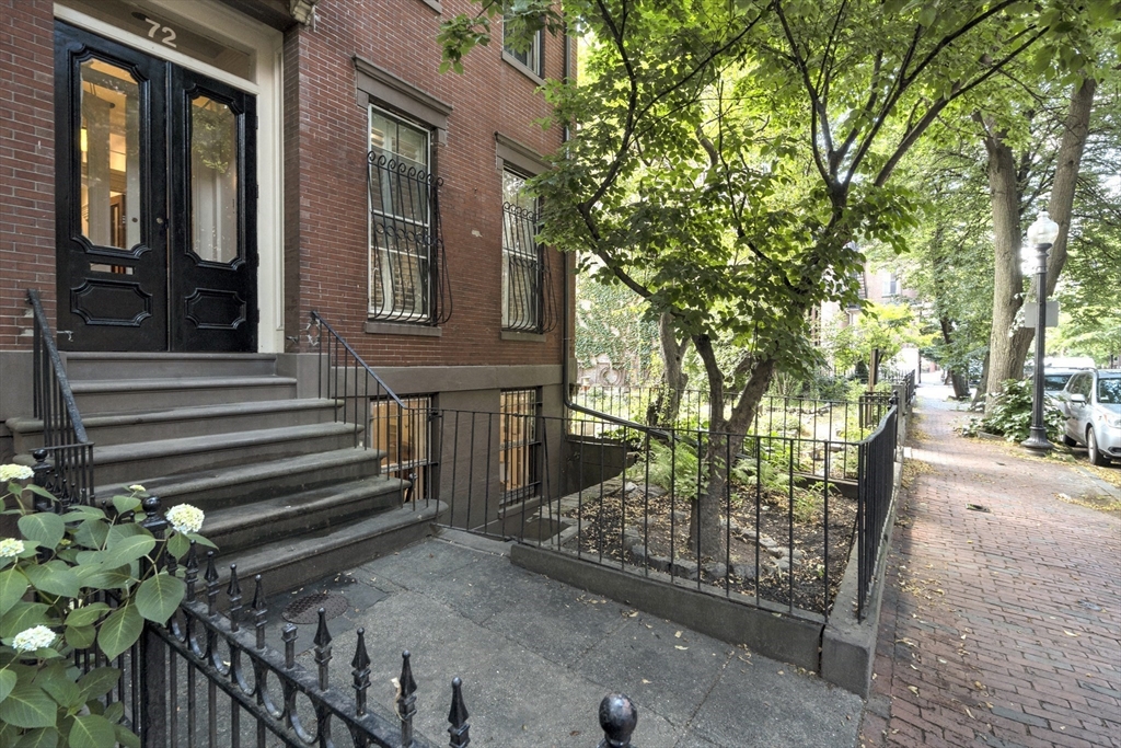 72 Rutland Street, Unit 1 Boston, MA 02118 - Photo 28 of 29 a view of a house with a wooden bench next to a road