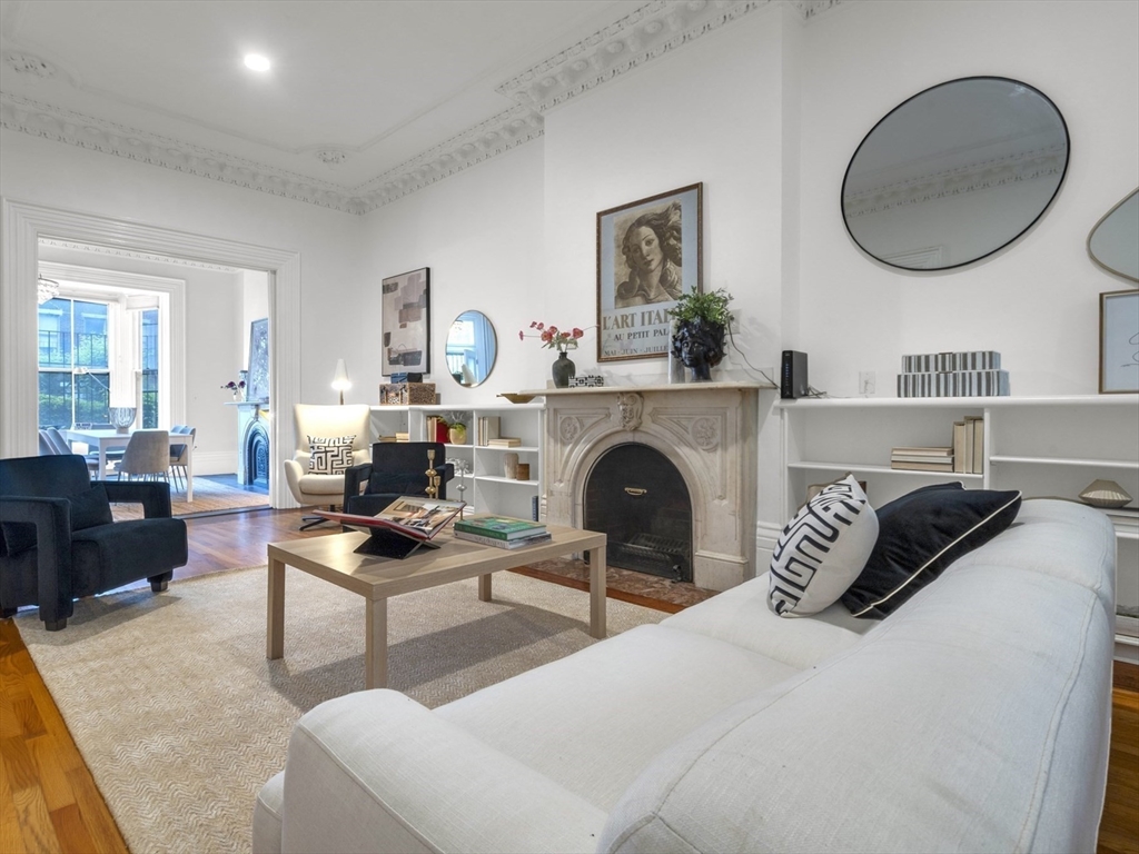 72 Rutland Street, Unit 1 Boston, MA 02118 - Photo 3 of 29 a living room with furniture a mirror and a fireplace