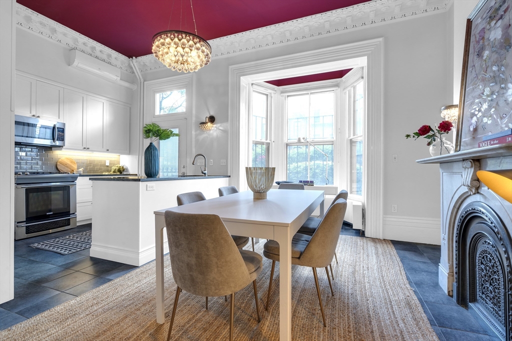 72 Rutland Street, Unit 1 Boston, MA 02118 - Photo 5 of 29 a view of a dining room with furniture a chandelier and wooden floor