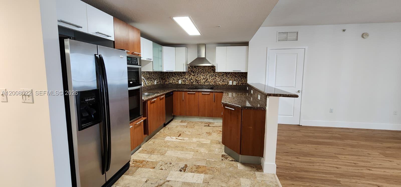 170 Southeast 14th Street, Unit 1408 Miami, FL 33131 - Photo 1 of 30 a kitchen with stainless steel appliances granite countertop a refrigerator and a stove