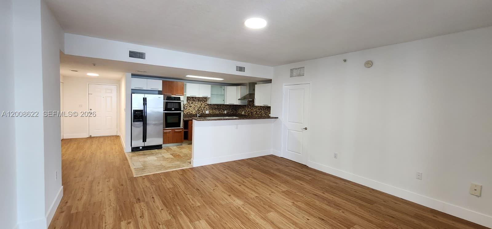 170 Southeast 14th Street, Unit 1408 Miami, FL 33131 - Photo 5 of 30 a view of kitchen with wooden floor