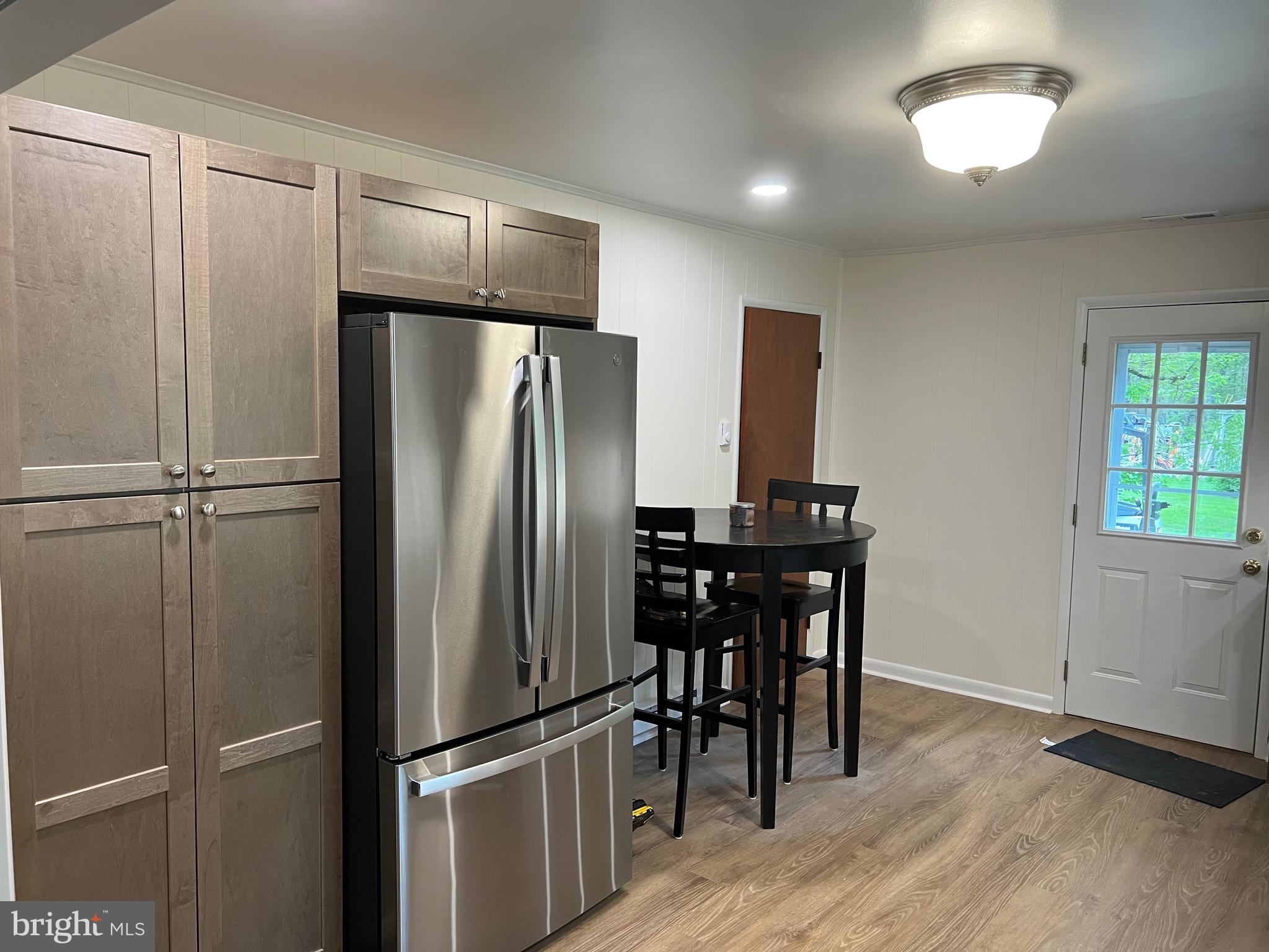 2617 Franklinville Road Joppa, MD 21085 - Photo 11 of 39 a kitchen with metallic refrigerator and wooden floor