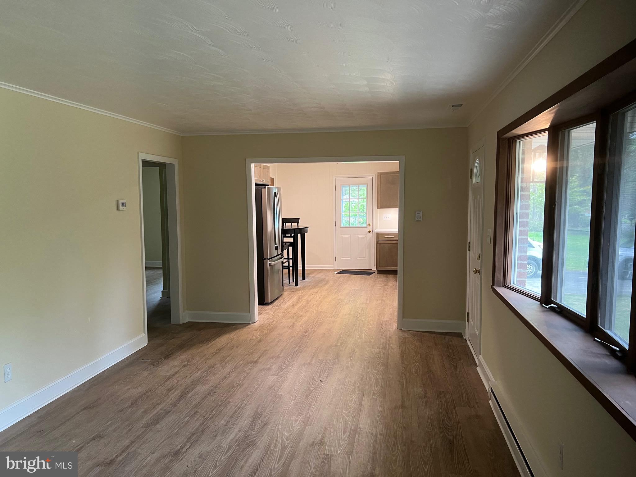 2617 Franklinville Road Joppa, MD 21085 - Photo 14 of 39 a view of a hallway with wooden floor and a living room