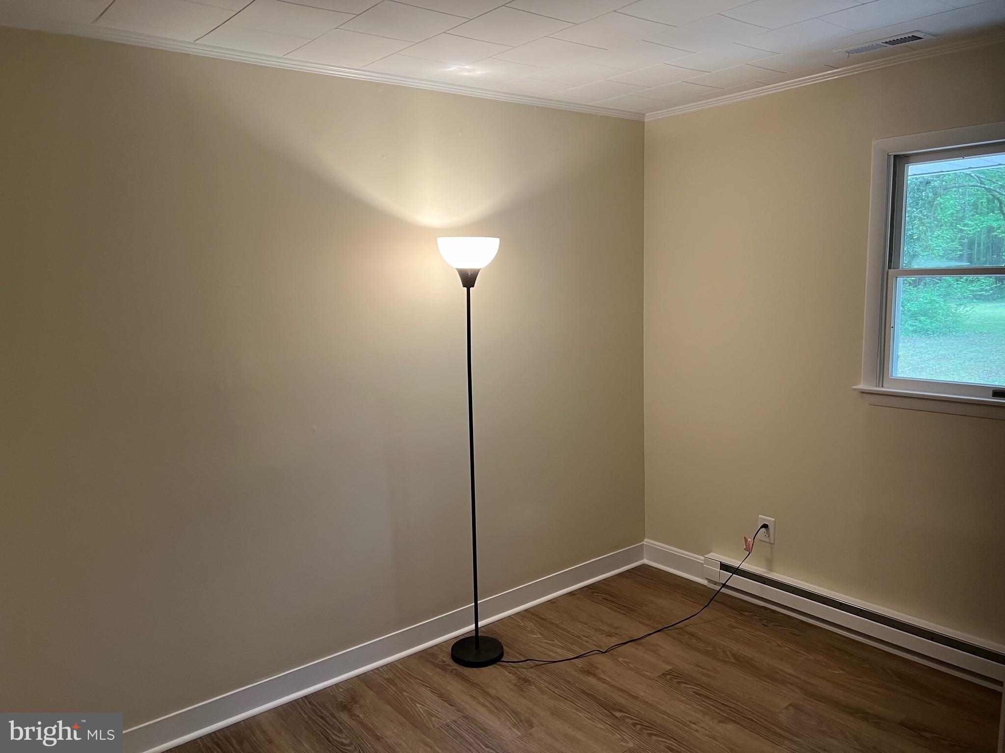 2617 Franklinville Road Joppa, MD 21085 - Photo 15 of 39 a view of an empty room with wooden floor and a window