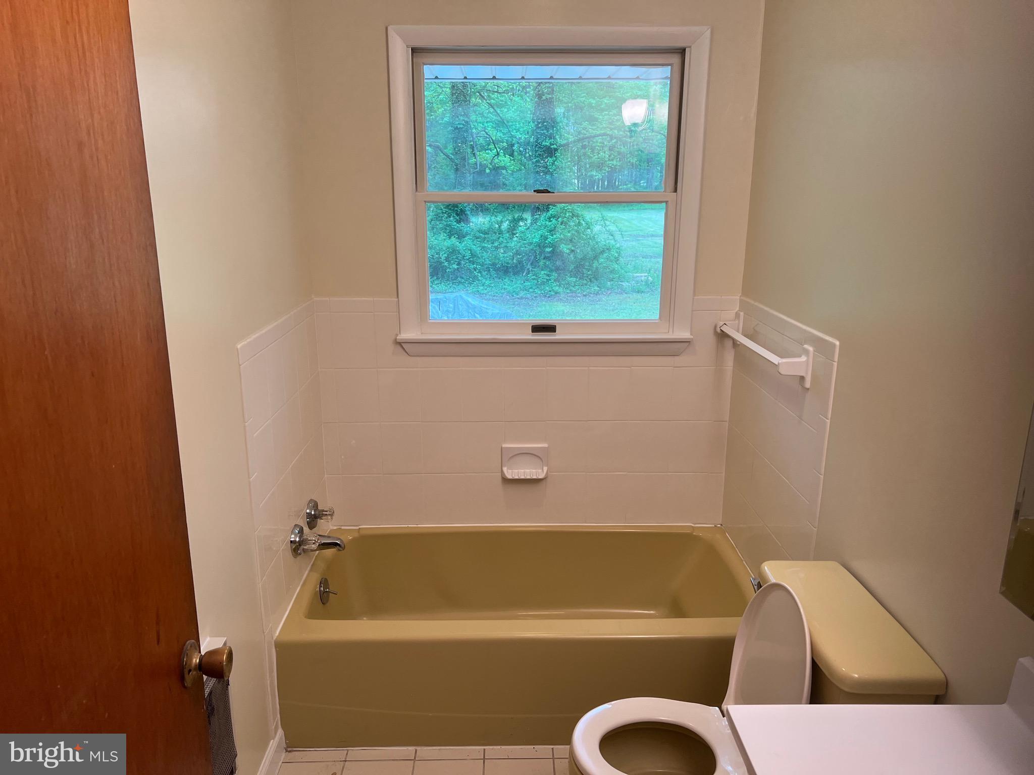 2617 Franklinville Road Joppa, MD 21085 - Photo 16 of 39 a bathroom with a tub and a window