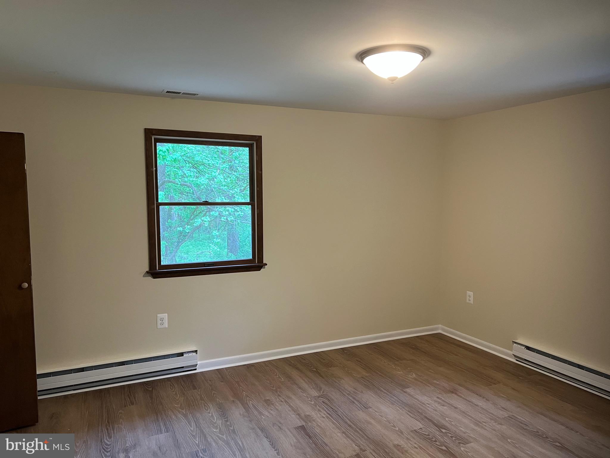 2617 Franklinville Road Joppa, MD 21085 - Photo 20 of 39 an empty room with wooden floor and windows