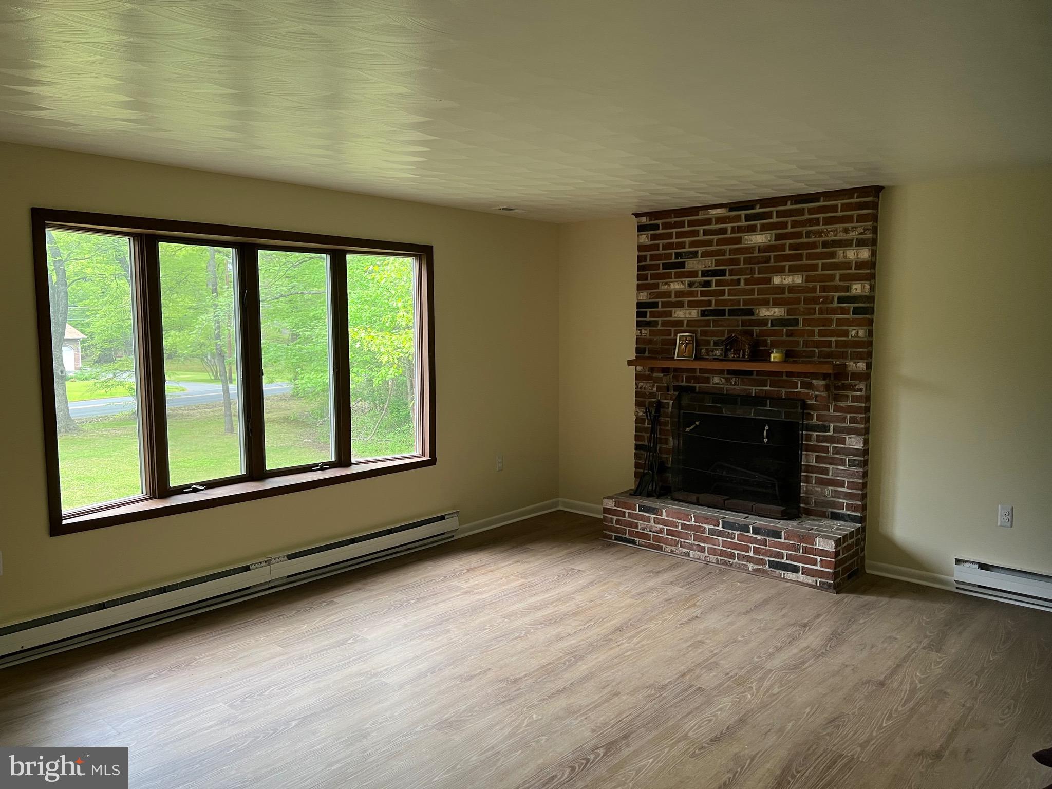 2617 Franklinville Road Joppa, MD 21085 - Photo 7 of 39 a view of an empty room with a fireplace and a window