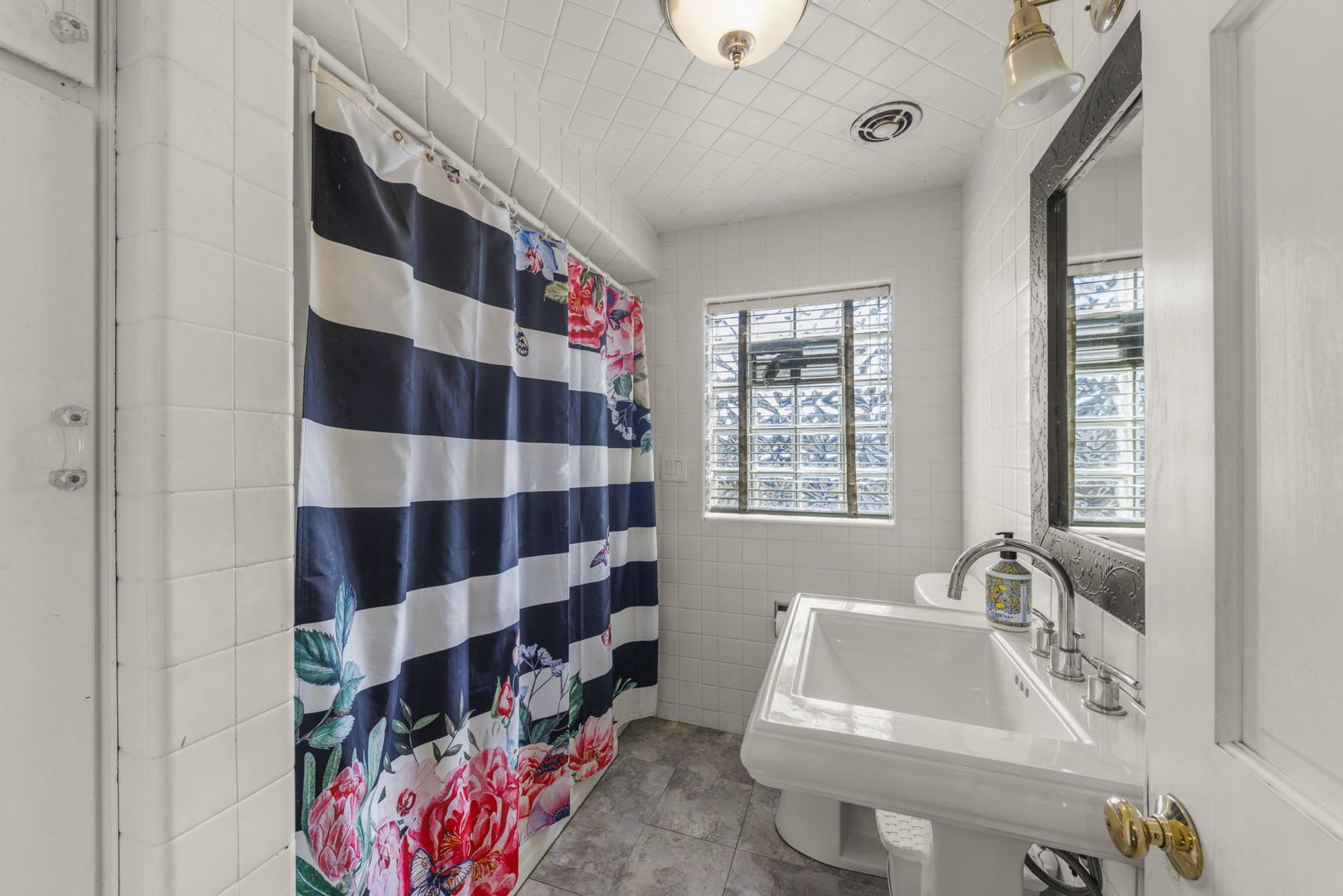 8119 Edgewater Road North Riverside, IL 60546 - Photo 12 of 26 a bathroom with a sink a toilet and shower curtain