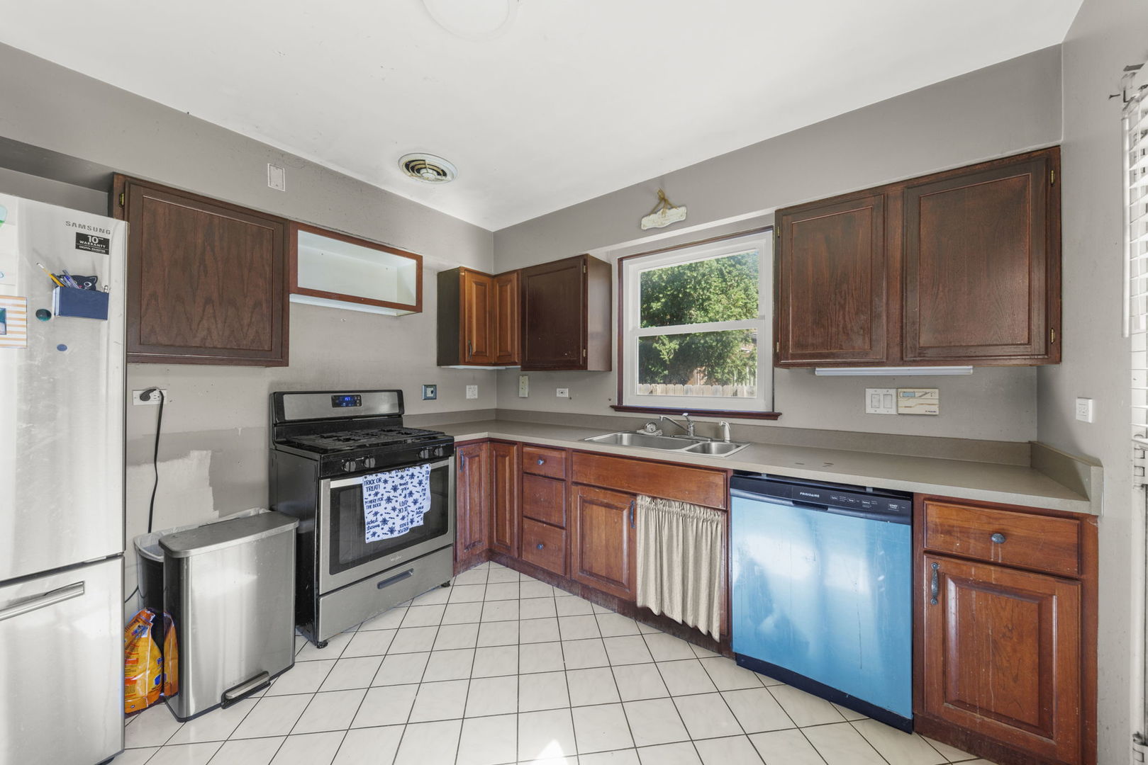 8119 Edgewater Road North Riverside, IL 60546 - Photo 8 of 26 a kitchen with stainless steel appliances granite countertop a refrigerator sink stove microwave and cabinets