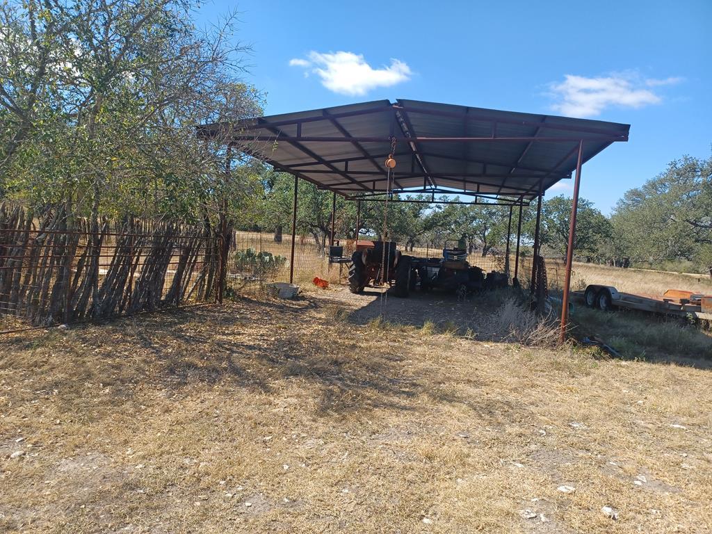 Tbd Lange Road Harper, TX 78631 - Photo 2 of 13 a view of patio with a table and chairs under an umbrella