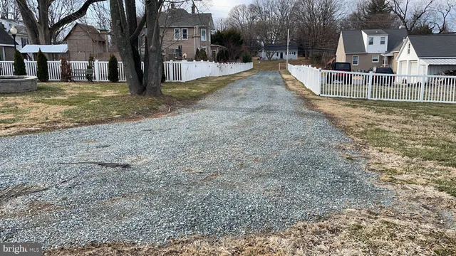 a view of a house with a yard covered in snow