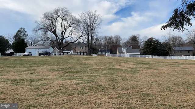 a swimming pool with trees in front of it