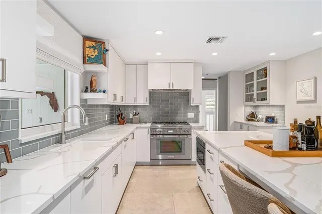 a kitchen with a sink stove top oven and refrigerator