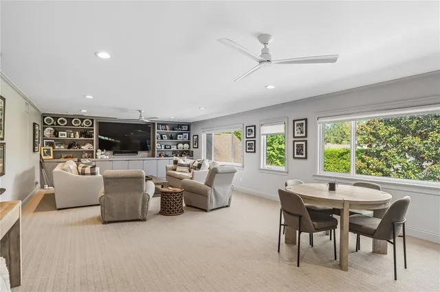 a living room with fireplace furniture and a large window
